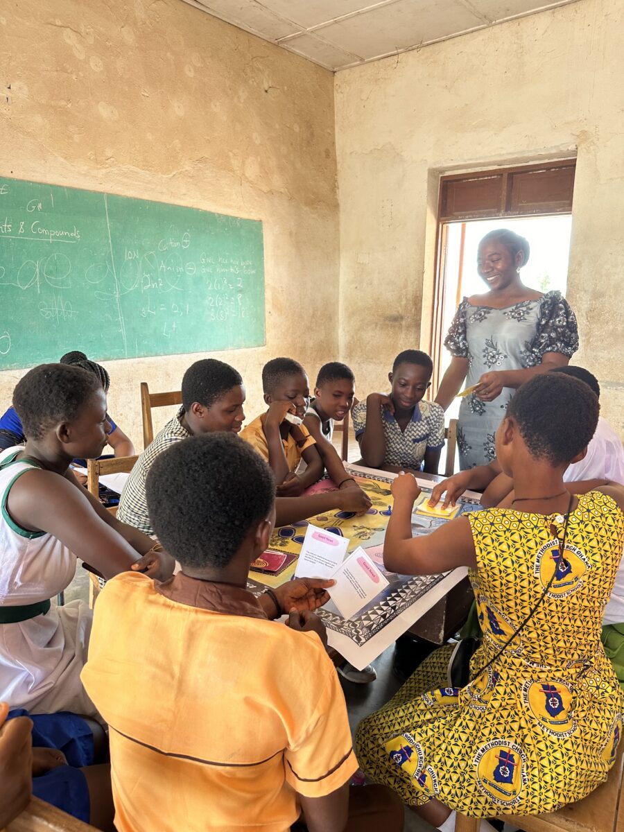 Girls in Ghana playing an instructional board game.