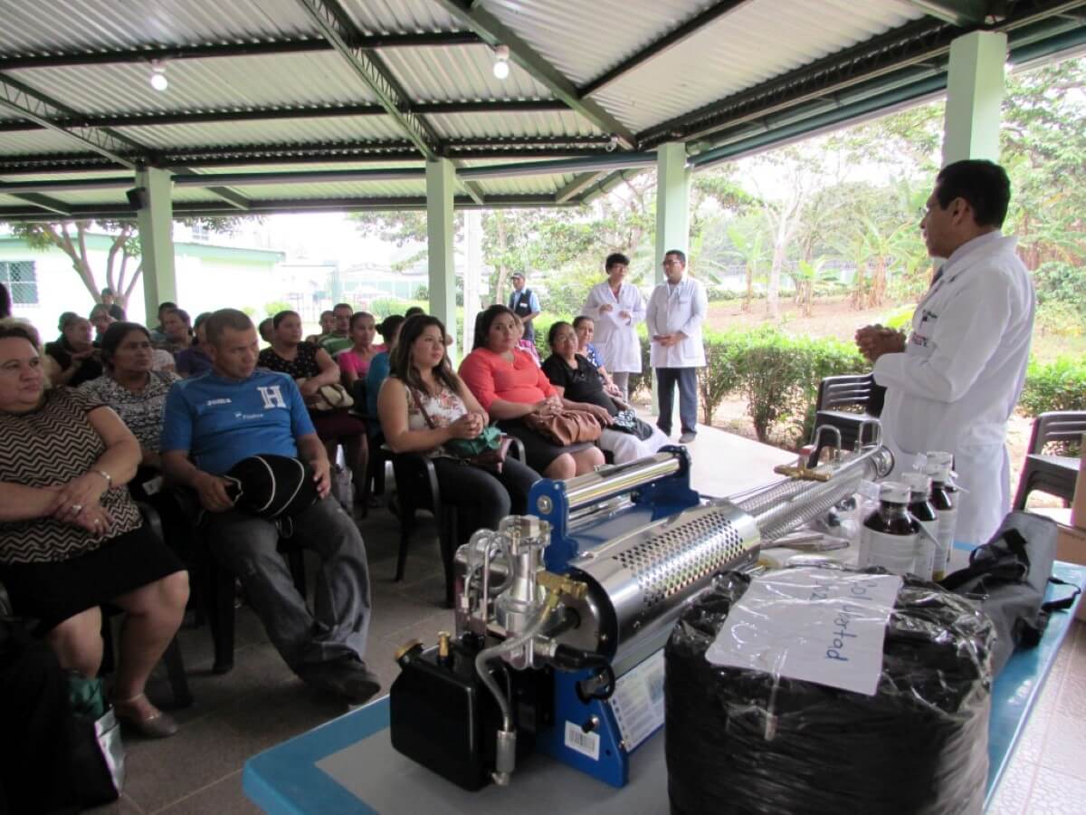 Doctor Quijano teaches a community about mosquito control.