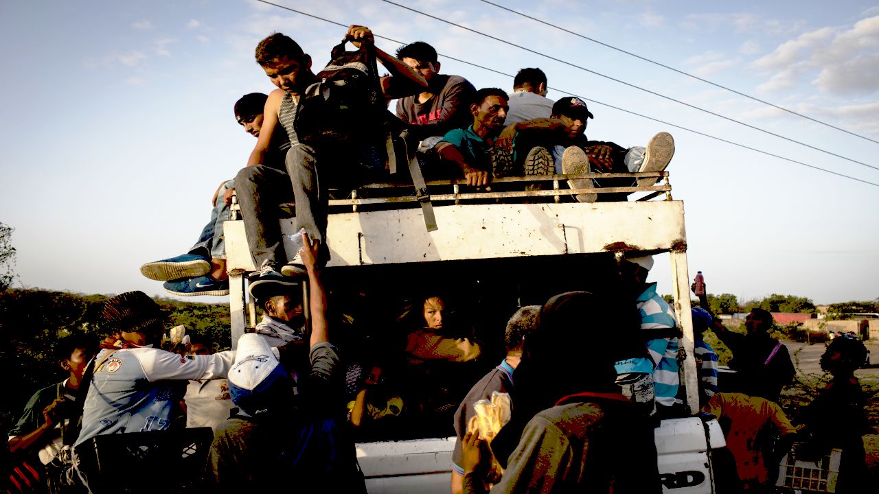 People cross the border between Colombia and Venezuela at the border town of Paraguachon, in La Guajira, passing by illegal shortcuts to avoid passports' controls and the toll's payment. Local Wayuu indigenous children charge a few Bolivares (Venezuelan currency) or a few Colombian pesos to let the cars cross the line. Americares responds to people’s needs in town by offering them basic medical aids in a recovered area of the old hospital of Maicao, La Guajira, Colombia, on July 5th, 2018. Children and pregnant mother receive the attention first. Since 2015 Venezuelans' mass migration to Colombia progressively increased. After crossing the border migrants start a long path, often by walk and lasting over three months, to Peru, Chile and Brazil in search of a new life and job opportunities, fleeing their country as President Nicolas Maduro consolidates autocratic power and food and medicine run out due to corruption. Americares is working on the health emergency response. Photographer: Nicolo Filippo Rosso/Americares