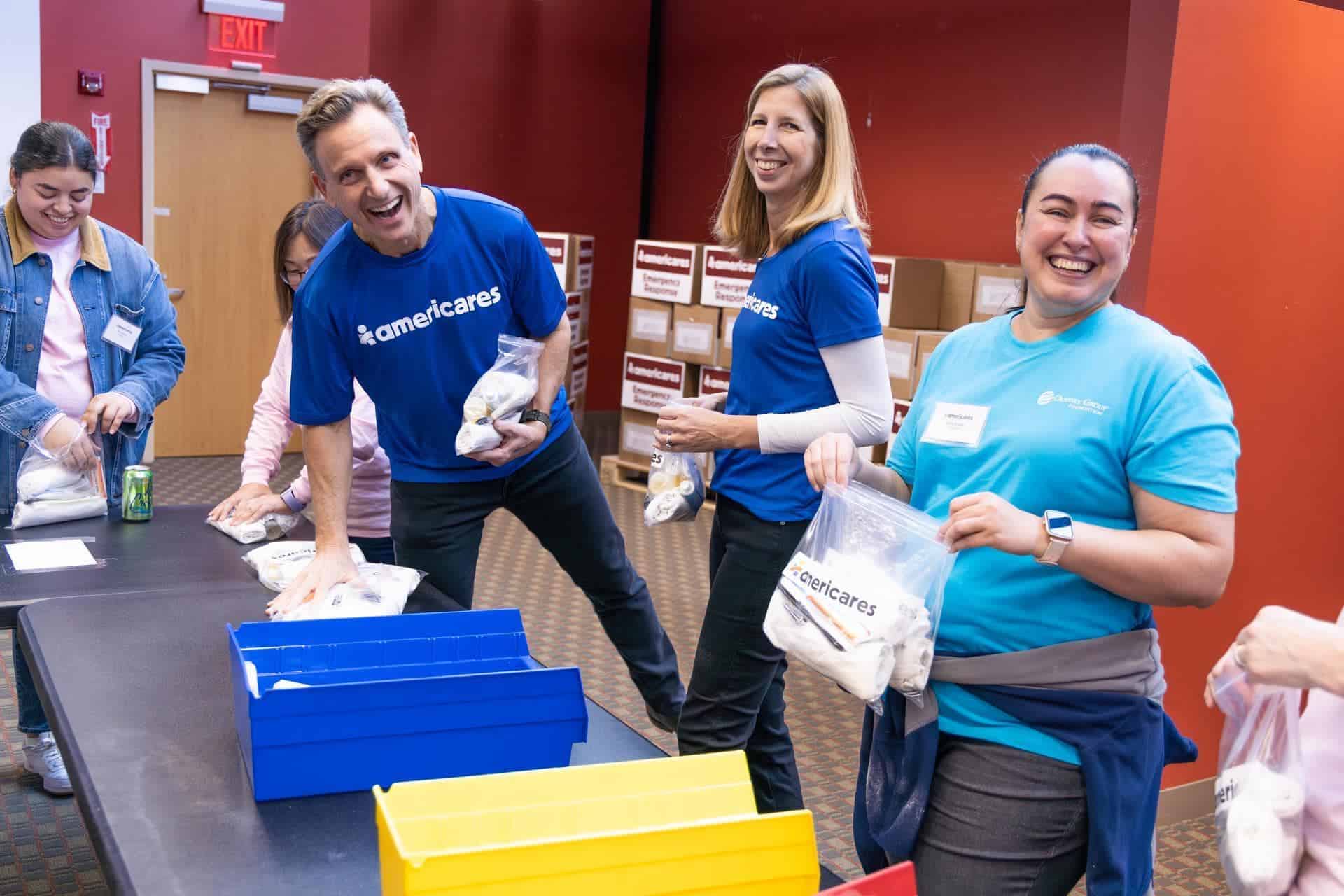 Tony Goldwyn joins Americares President and CEO Christine Squires and volunteers to pack hygiene kits for disaster survivors